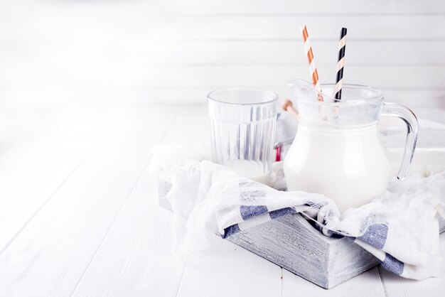 milk in the glass with straws and honey 