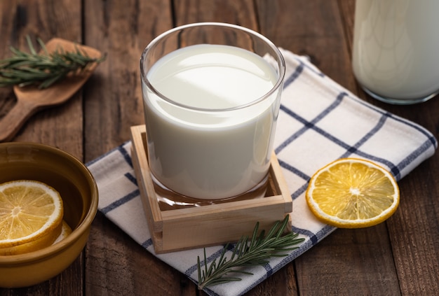 milk in glass on wood food background