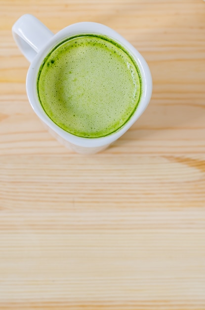 Milk green tea on wooden table