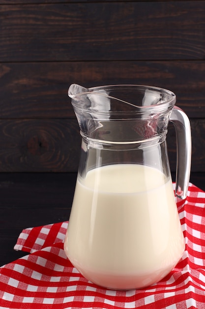 Milk in a jug on dark boards 