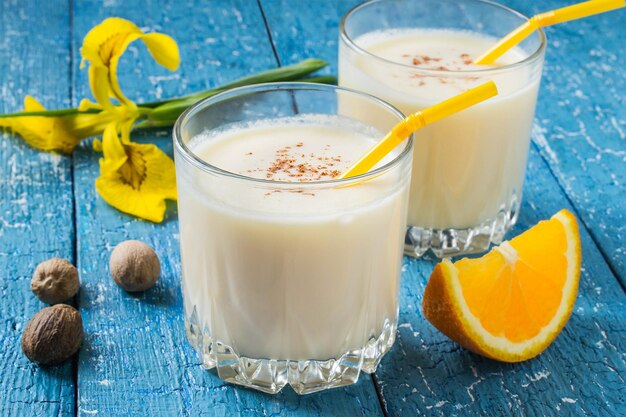 Milk and orange cocktail with nutmeg