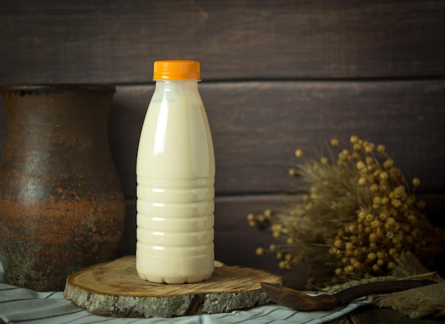 Milk in a plastic bottle on a rustic background minimalism copy space