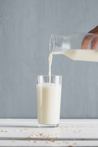 Milk pourred in glass with bottle