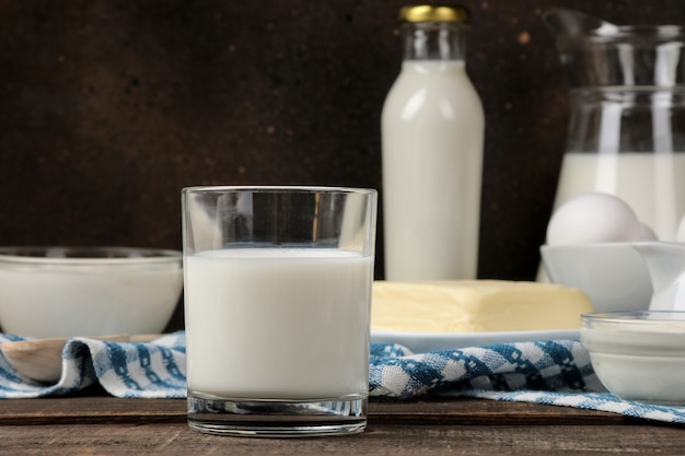 Milk products. milk, sour cream, cheese, butter and cottage cheese on a brown wooden table