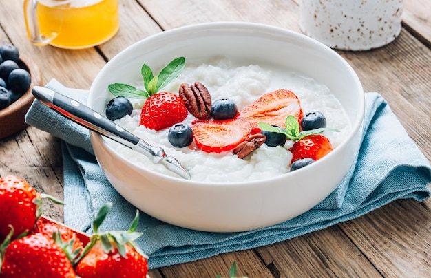 Milk rice porridge with blueberries and strawberries