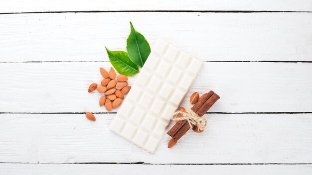 Milk white chocolate with almond nuts On a wooden background Top view Copy space for text