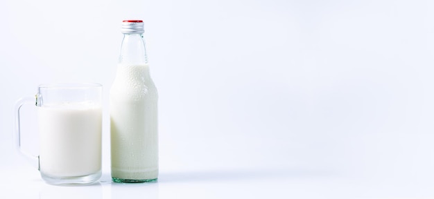 milknatural milk in jug and glass isolated on white background closeup