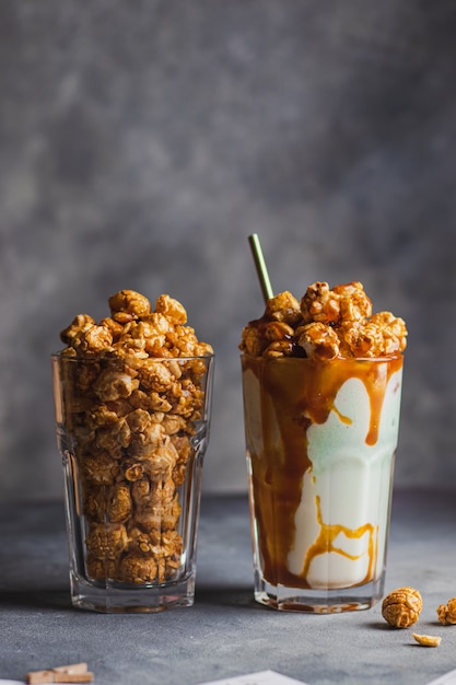 Milkshake with caramel sauce decorated by popcorn