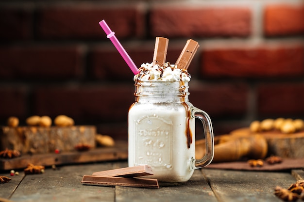 Milkshake with chocolate on a brick wall background