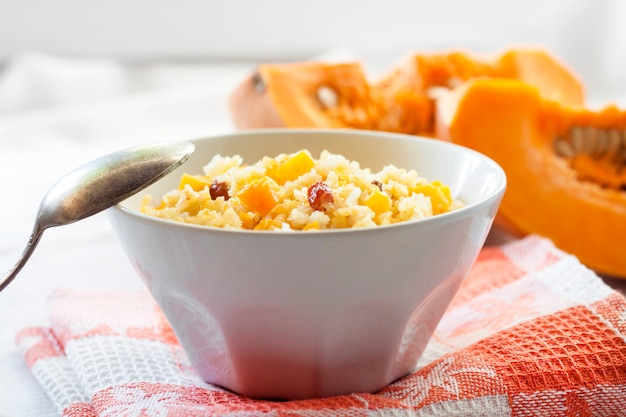 Milky cereal porridge with pumpkin and raisins