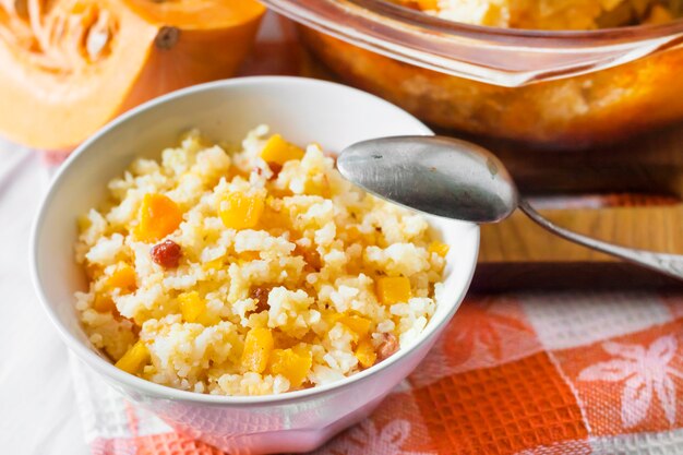 Milky cereal porridge with pumpkin and raisins