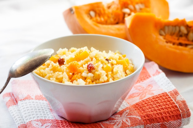 Milky cereal porridge with pumpkin and raisins