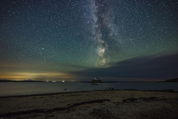 Milky Way and night sky over St Cwyfans Church at Anglesey Wales