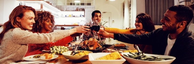 Millennial adult friends celebrating Thanksgiving together at home