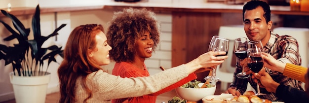 Millennial adult friends celebrating Thanksgiving together at home