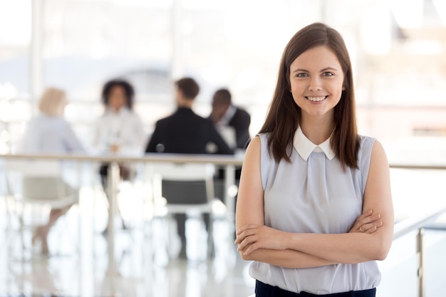 millennial ambitious team leader young employee hr manager female worker intern girl smiling looking at camera happy successful professional or business coach posing in modern office portrait