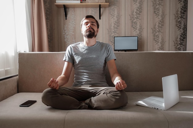 Millennial hipster guy enjoy no stress peace of mind lounge on sofa at home