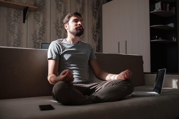 Millennial hipster guy enjoy no stress peace of mind lounge on sofa at home