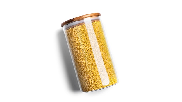 Millet cereal in a glass jar isolated.