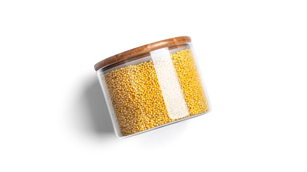 Millet cereal in a glass jar isolated.