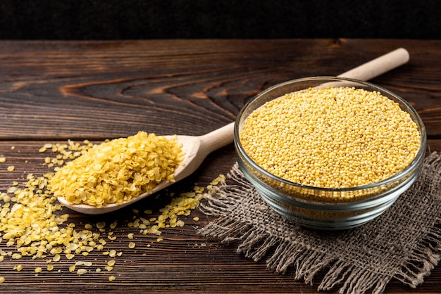 Millet flakes on dark wooden