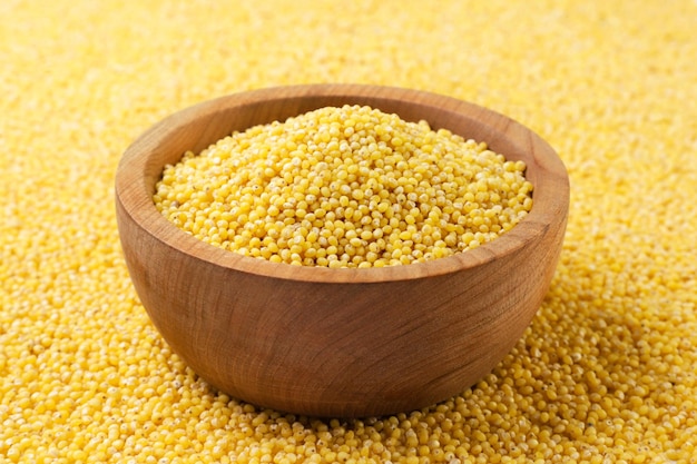 Photo millet in a wooden plate closeup background