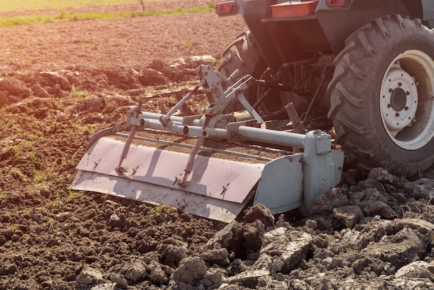 Milling mashine loosens and cultivates soil on field