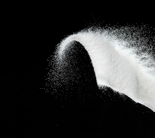 Million of white sand explosion Photo image of falling down shower snow heavy snows storm flying Freeze shot on black background isolated overlay Tiny Fine Salt sands as particle science