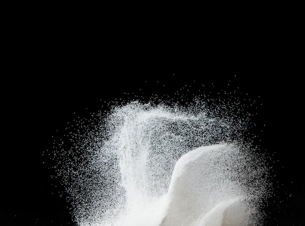 Million of white sand explosion Photo image of falling down shower snow heavy snows storm flying Freeze shot on black background isolated overlay Tiny Fine Salt sands as particle science