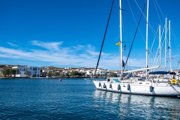 Milos island Adamas port Cyclades Greece Moored boats buildings background