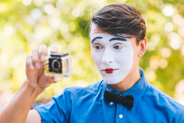 Mime in blue shirt shoot video on camera