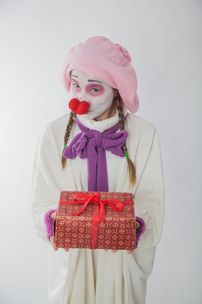 Mime girl with a gift in her hands Emotions from a gift