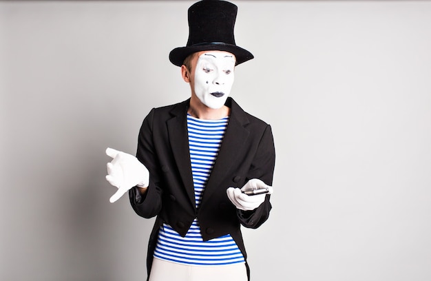 Mime with smartphone. Concept of April Fools Day.