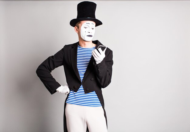 Mime with smartphone. Concept of April Fools Day.