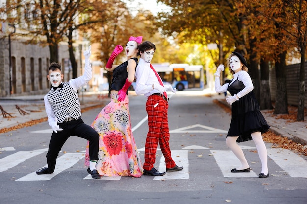 Mimes on a background of autumn trees