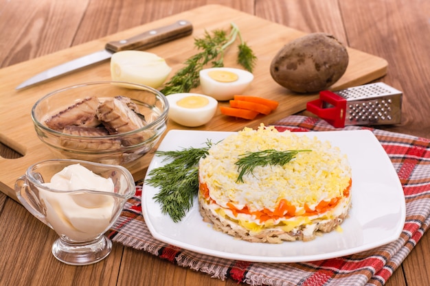 Mimosa salad and ingredients for its preparation on the table