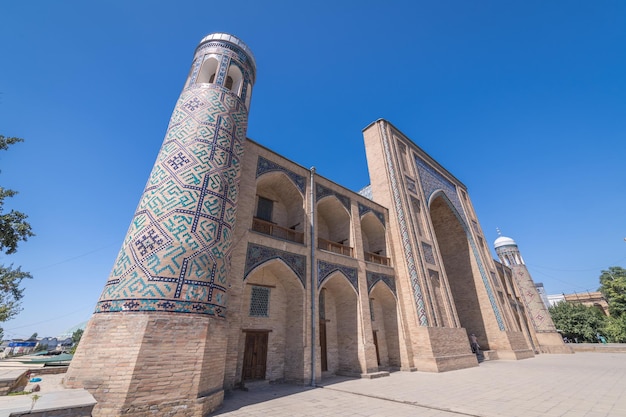 Minaret tower with blue mosaic tiles of kukeldash madrasah tashkent uzbekistan vertical image with copy space for text