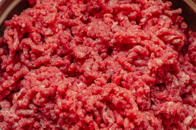 Minced beef close-up in a metal plate. Minced cutlets cooking for dinner. beef, grinder, raw, food, meat, cooking.