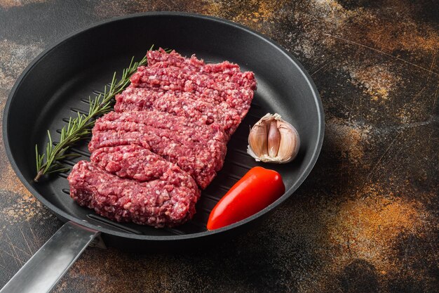 Minced meat beef, on old dark rustic background