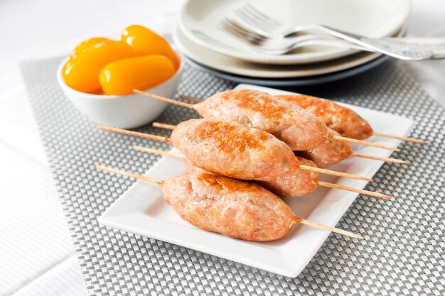 Minced turkey kebabs on square white plate