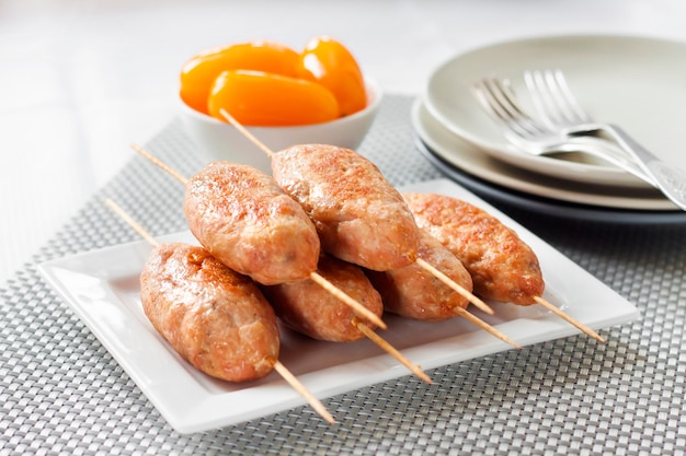 Minced turkey kebabs on square white plate