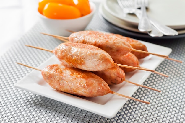 Minced turkey kebabs on square white plate