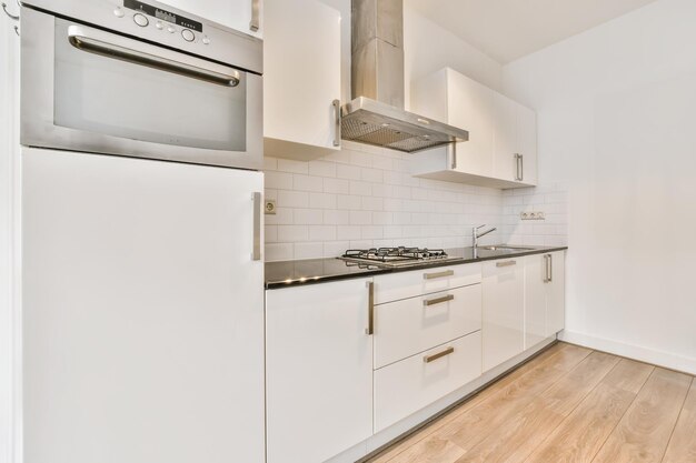 A mindblowing small kitchen in light colors with a white kitchen set