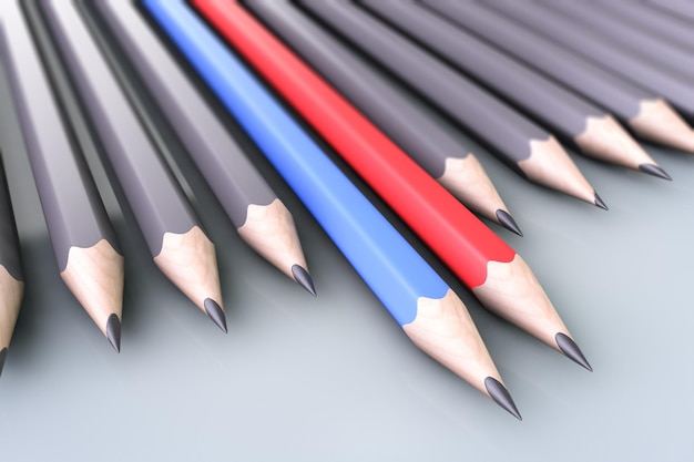 Minderheids- en meerderheidsconcept Twee kleurpotloden onder grijze potloden