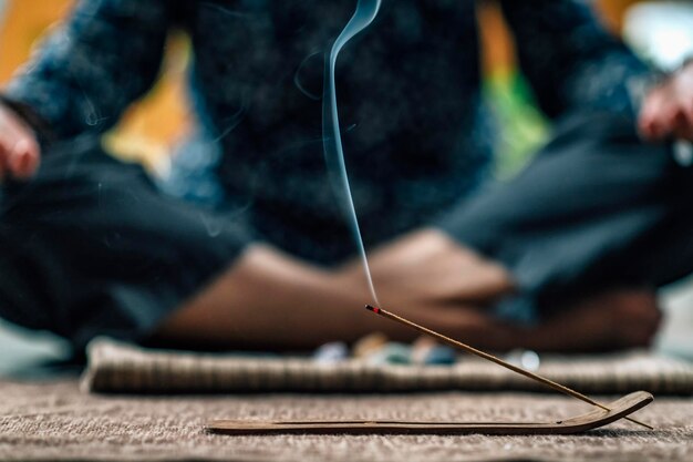 Mindful Woman Meditating with Burning Incense Sticks Sitting in Lotus Pose Hands