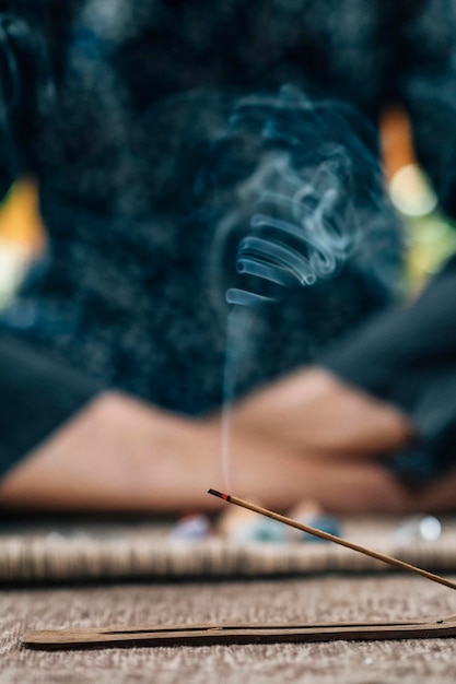 Mindful Woman Practicing Daily Meditation with Incense Sticks Burning