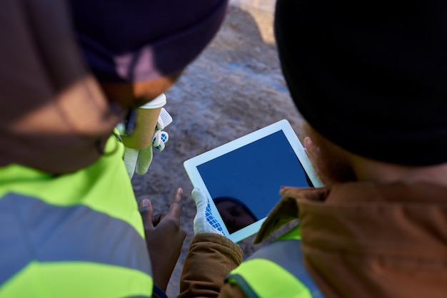 Miners Using Tablet Outdoors