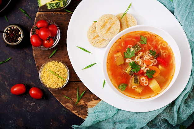 Minestrone - "big soup", soup with many ingredients - a dish of Italian cuisine, light seasonal vegetable soup with pasta.