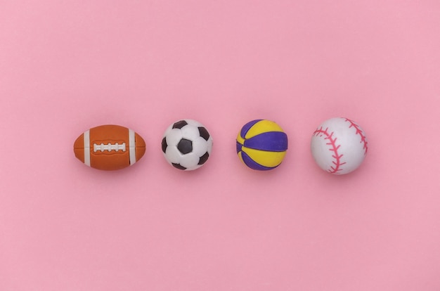 Mini balls of different sports on pink background. Minimalism Sport concept. Top view. Flat lay.