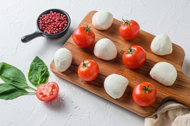 Mini balls of mozzarella cheese, on chop wood board ingredients for salad caprese
